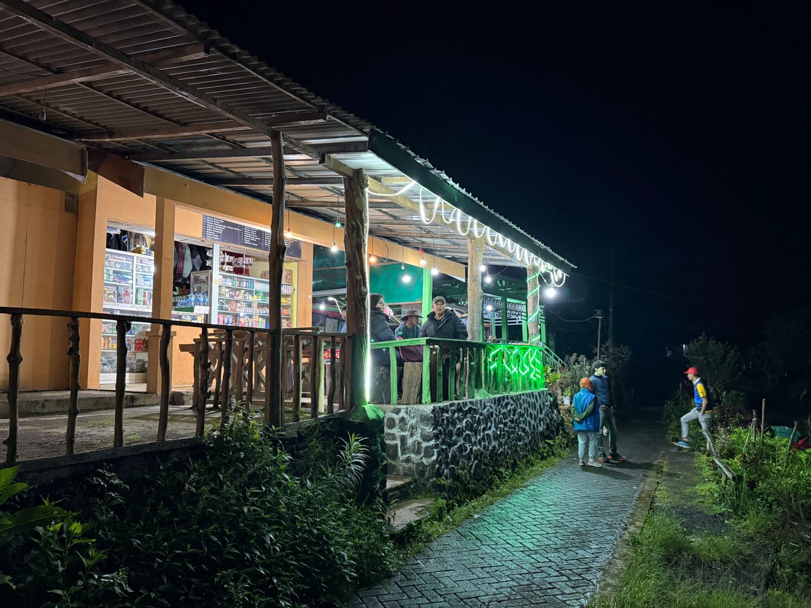 Hikers gathering in the early hours at Ijen Volcano’s basecamp in Indonesia, preparing for a midnight trek to catch the sunrise at the summit.