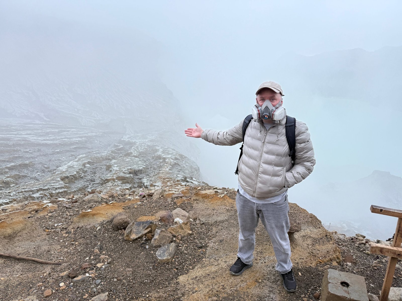 Don Trynor, wearing an N95 mask, stands partway down Ijen Volcano’s caldera in Indonesia, surrounded by sulfur-laden air.