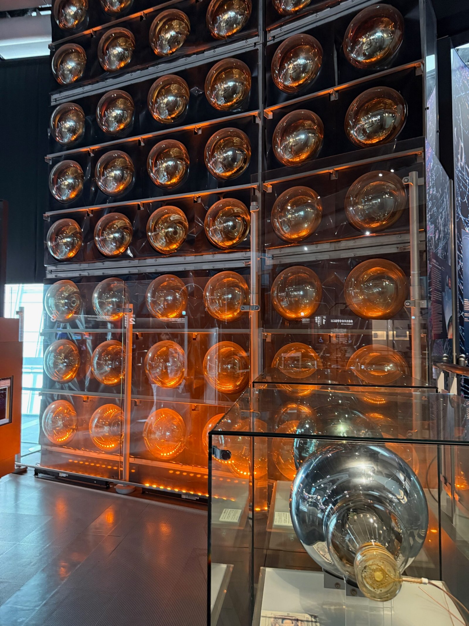 Replica neutrino detectors on display at Miraikan, illustrating how scientists detect these ghostly particles.