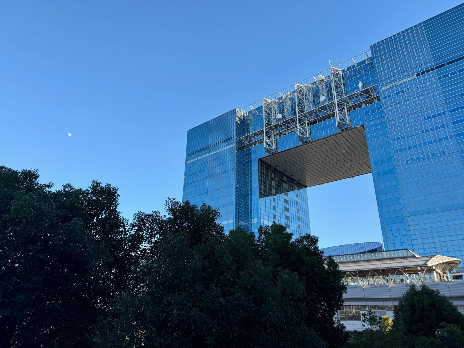 Telecom Center Building in Odaiba near Miraikan, with the moon rising to the left.