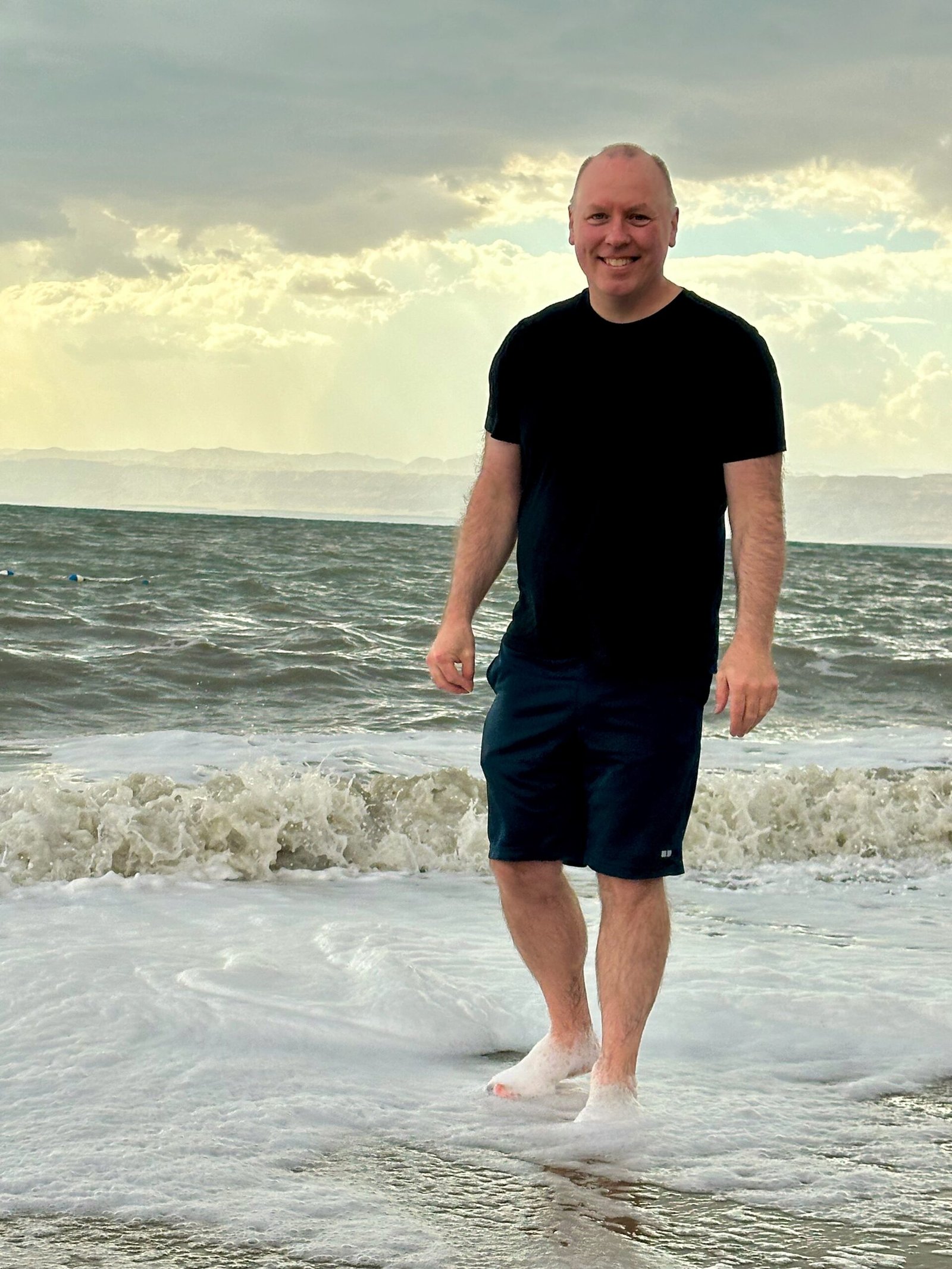 Don Trynor, author of the Curious Don website, standing in the highly saline waters of the Dead Sea on a private beach in Swemeh, Jordan.